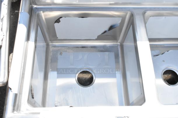 Regency 600S31717 60" three-compartment stainless steel sink with 17" x 17" x 12" bowls. Minor scratches and dents visible.