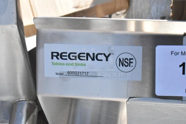 Regency 600S31717 60" stainless steel three-compartment sink, model tag visible, NSF certified, brand new with minor scratches.