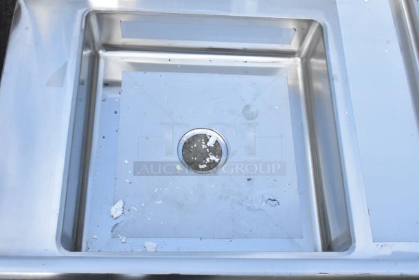 Brand new Regency 600DDT36R 16-gauge soiled dish table with right drainboard, minor scratches and dents visible.