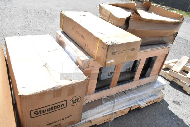 Brand new auction items on a pallet, including Steelton underbar ice bin and Regency equipment table in original packaging.