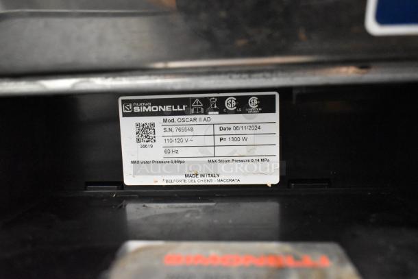 Nuova Simonelli Oscar II AD tag showing model, serial number 765548, voltage 110-120V, 1300W, made in Italy.
