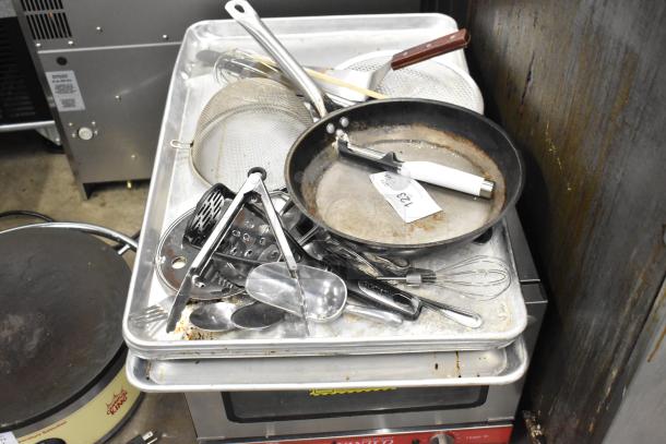 Lot of various kitchen items including a rusty skillet, utensils, strainers, and tongs, tagged with "ALL ONE MONEY 123."