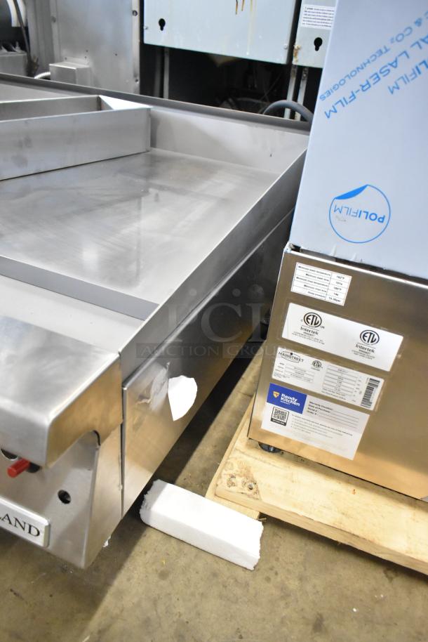 Brand new Garland stainless steel commercial gas griddle, scratch and dent condition, with visible packaging and certification labels.