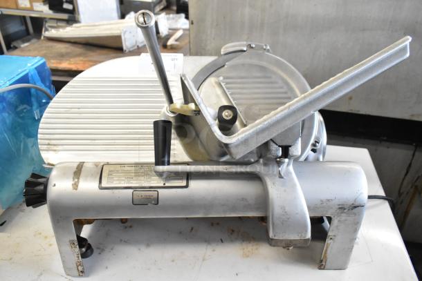 Hobart 1612 metal meat slicer, commercial countertop model. 115V, 1 phase. Visible markings; used condition.