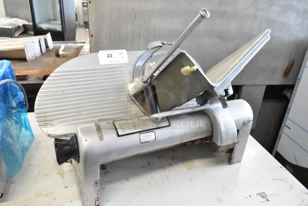 Hobart 1612 metal commercial meat slicer, 115 volts, 1 phase, used condition, with visible wear and label showing model details.