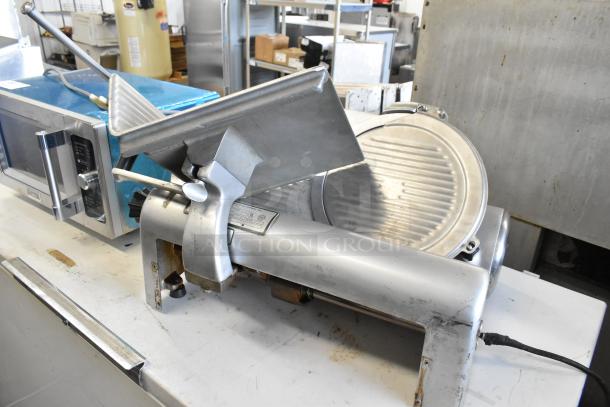 Hobart 1612 metal commercial meat slicer, showing moderate wear. 115 volts, single phase. Blade and adjustment knob visible.