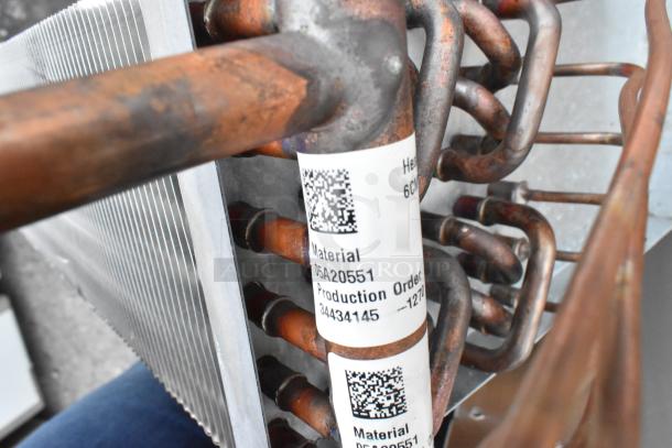 Brand new 2023 evaporator coil model 23-6-3/16-9P-E69, material code 05a20551, with copper tubing and production order label.