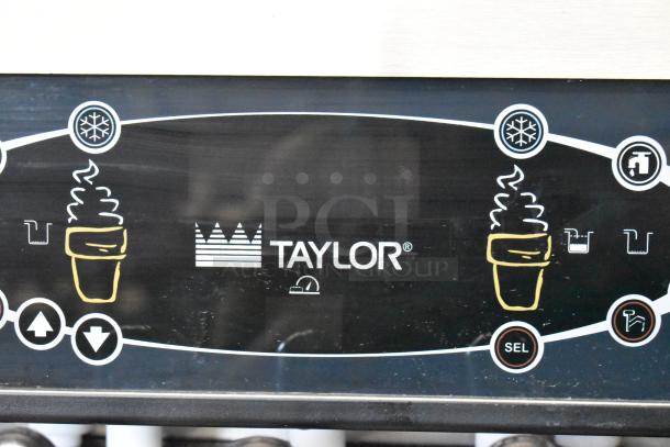 Taylor C723-33 soft serve machine, stainless steel, water-cooled, dual flavor with twist, commercial casters, control panel.