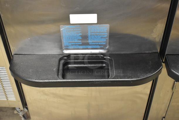 Taylor C723-33 stainless steel soft serve machine with two flavors and twist feature, water-cooled, on commercial casters.