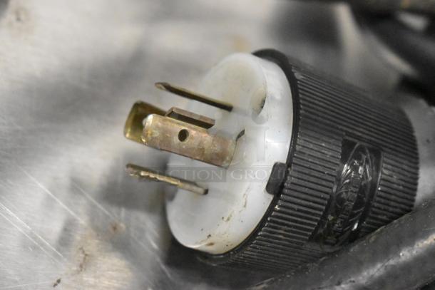 Close-up of a plug for Taylor C723-33 ice cream machine, showing prongs and housing. Used condition.