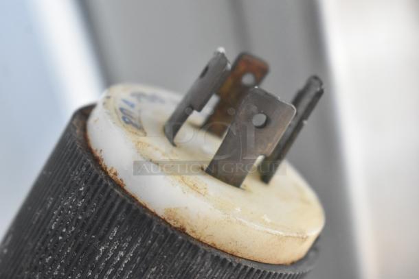 Alt text: Close-up of a plug from a Hobart V-1401 mixer, showing the metal prongs and part of the connector.
