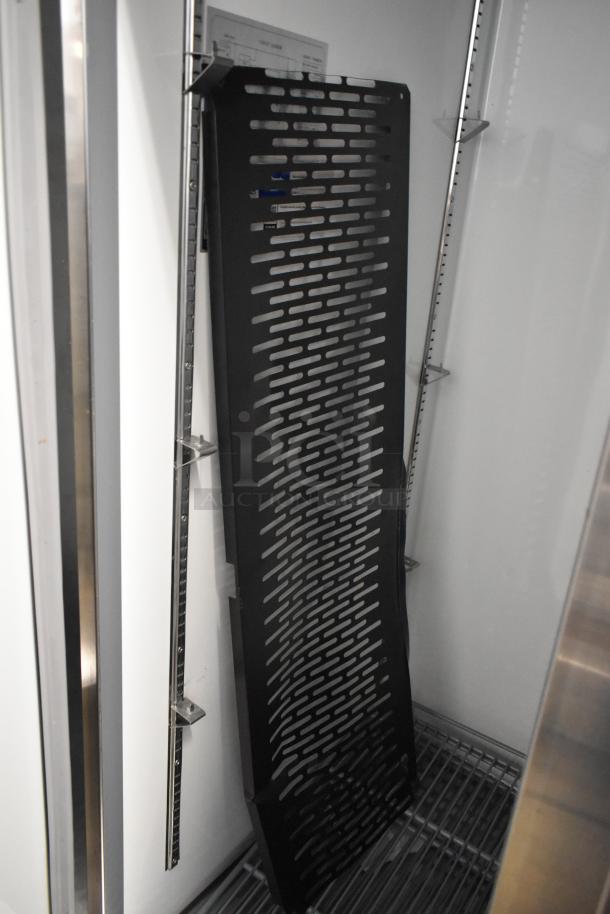 Brand new Avantco 178A35RHC stainless steel commercial cooler. Interior view shows poly coated racks and mounting rails.