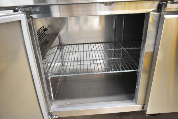 BRAND NEW Avantco 178SSUD3R stainless steel 3-door undercounter cooler, commercial casters, 115V, 1 phase, interior view.
