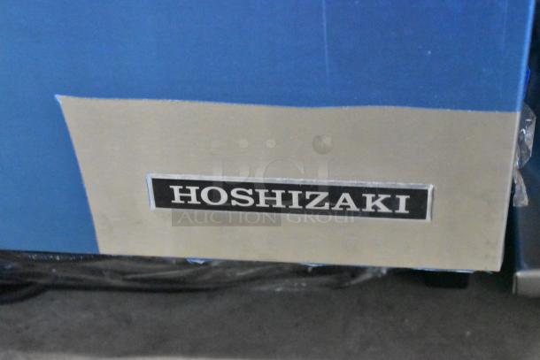 Brand new Hoshizaki C-80BAK stainless steel ice machine, 27 lb. bin, 92 lb. output, visible scratch and dent, label shown.