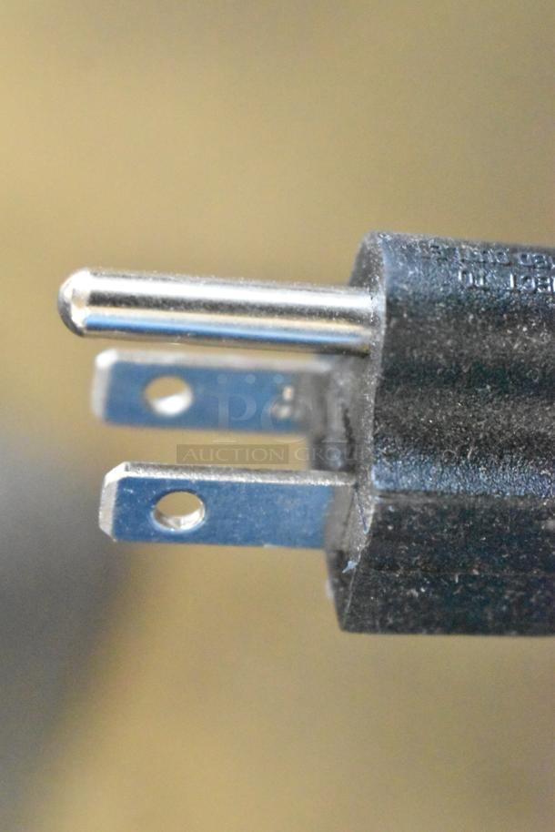 Close-up of a power plug for the Curtis ALP3GT63A000 coffee brewer. Black casing with metal prongs.