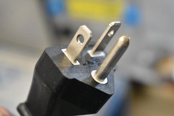Close-up of the power plug from a 2024 Estella 348WSMXS2A stainless steel commercial waffle maker, 120 volts, 1 phase.
