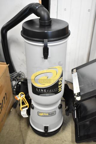 Brand new ProTeam LV-100 backpack vacuum, 120 volts, 1 phase. Features HEPA filter, visible tags, slight scratches.
