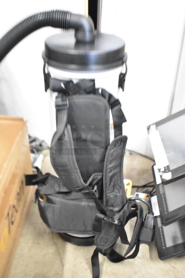 Brand new ProTeam LV-100 backpack vacuum, 120V, 1 phase, scratch and dent, with padded straps and hose connection.