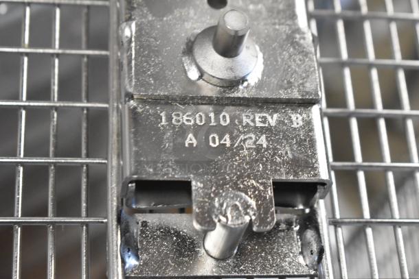 BRAND NEW Henny Penny 186010 fryer basket, designed for 600 Gas Fryer. Slight scratches, metal grid, "186010 REV B A 04/24" marking.