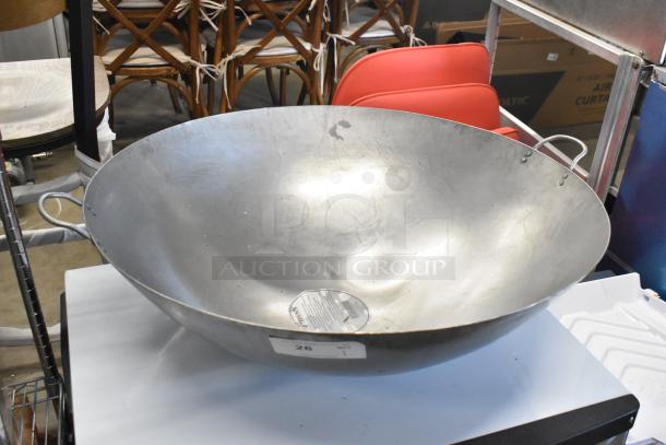 Brand new 30" hand hammered Cantonese wok by Town. Scratch and dent condition, features metal handles and label detailing.