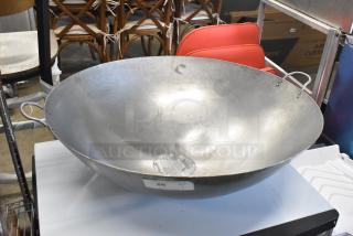 Brand new 30" hand hammered Cantonese wok by Town. Scratch and dent condition, features metal handles and label detailing.
