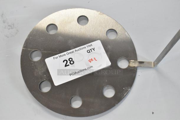 Stainless steel skimmer with round, perforated design, labeled "28" from PCI Auctions. Item in new condition with minor scratches.
