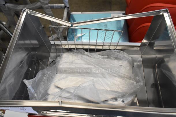 Brand new Avantco 177HDS100 stainless steel hot dog steamer, holds 100 dogs/48 buns, 120V, minor dents visible.