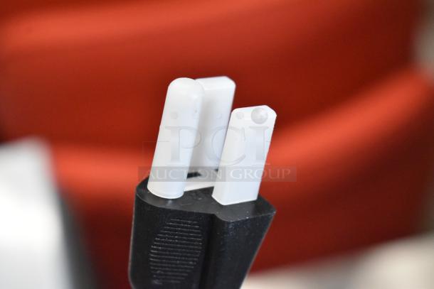 Close-up of Avantco 177HDS100 hot dog steamer plug, showing three white prongs on a black base.