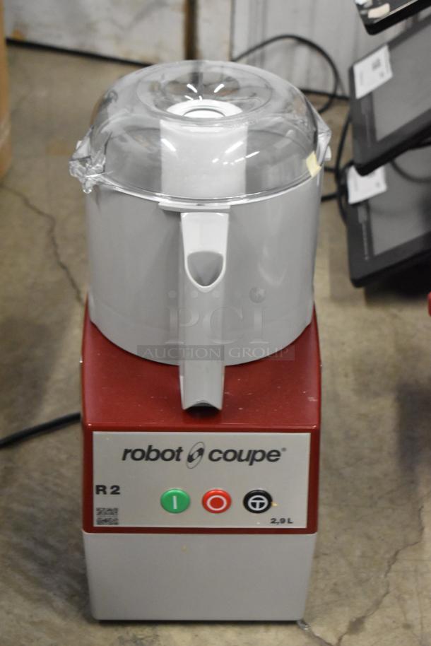 Brand new Robot Coupe R2 food processor with 3 qt gray bowl, continuous feed, 3 blades; minor scratches, 120V, 1 phase.