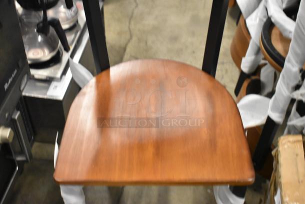 16 new Lancaster Table & Seating dining chairs, black metal frame, wooden backrest and seat, minor scratches.