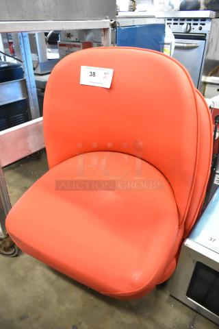 Brand new red bucket seat without legs, showing minor scratches. Auction tag reads "38 QTY Y5."