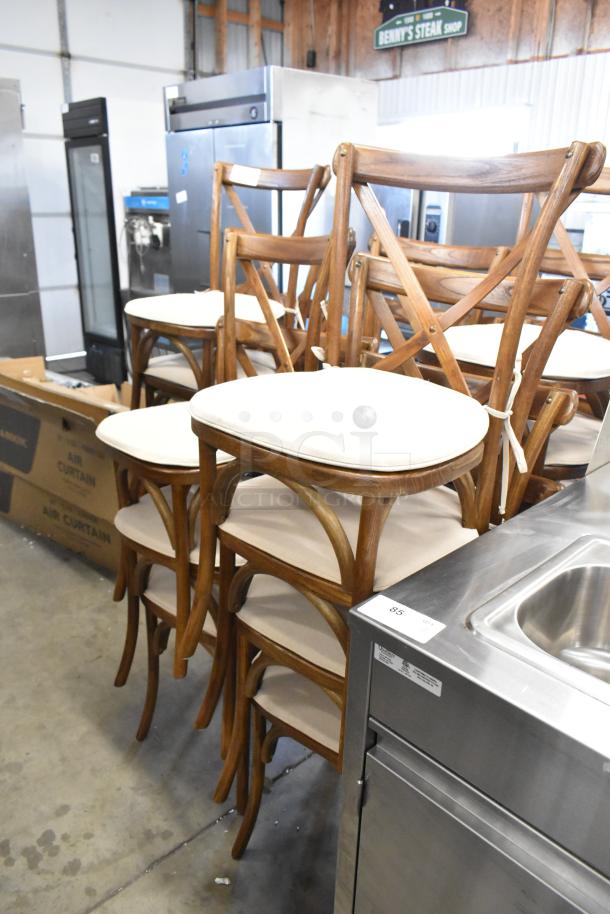 Set of 18 brand-new wooden dining chairs with cross backs and tan seat cushions, excellent condition, auction lot.