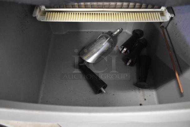 2022 Ice O Matic ICEU150FW8 ice machine interior with metal scoop and black fittings, self-contained, 115V, 1 Phase.