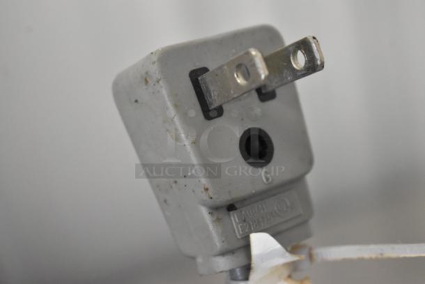 Close-up of a slightly worn electrical plug on the 2022 Ice O Matic ICEU150FW8 commercial ice machine, 115 volts, 1 phase.