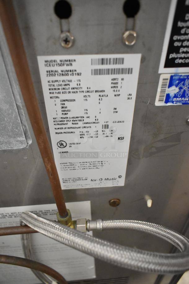 2022 Ice O Matic ICEU150FW8 metal commercial ice machine with visible specifications label, 115 volts, self-contained.