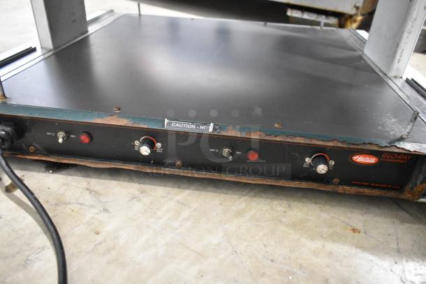 Hatco GR2SDH-24D heated display shelf, metal, countertop, 120V, rust visible, with knobs and caution label on front panel.