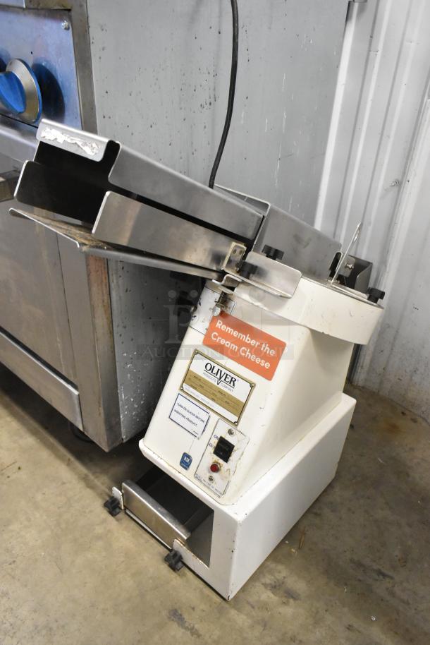 Oliver 702-N Metal Commercial Bagel Slicer, 115V, 1 Phase, countertop model. Features branding and operational labels.