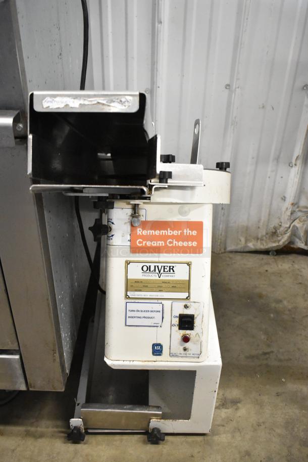 Oliver 702-N Commercial Countertop Bagel Slicer, 115 Volts, 1 Phase, visible model and safety labels, used condition.
