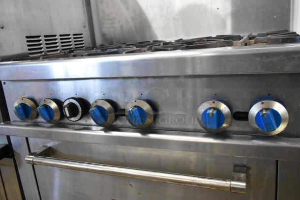 Standard Range SR-R36 stainless steel natural gas 6-burner range with oven, over shelf, backsplash, on casters. Good condition.