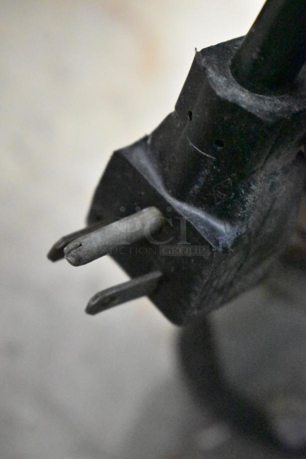 Close-up of a worn power plug related to the Electro Freeze 876-214 frozen beverage machine.