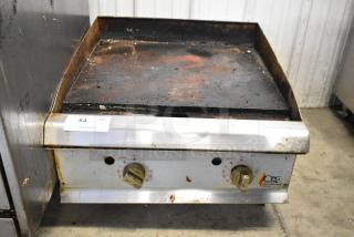 Cooking Performance Group stainless steel gas griddle with dual knobs, showing signs of use. Model: CPG. Item tag reads "53."