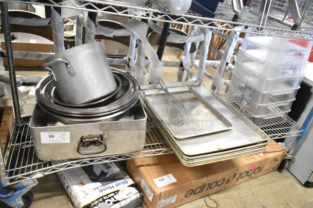 Tiered lot of kitchen items including metal baking pans, poly containers, and a pot on a wired shelf. Some wear visible.