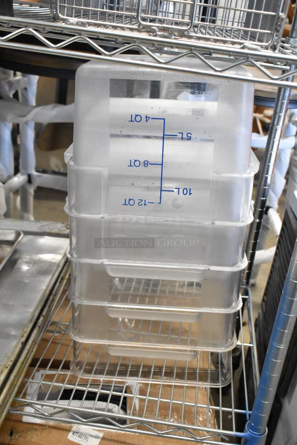 Stack of clear poly containers with volume measurements on side, on metal shelving. Includes metal baking pans. Used condition.