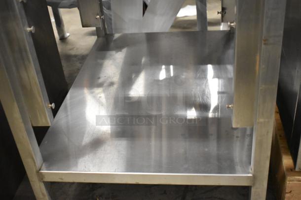 Stainless steel equipment stand with under shelf, featuring polished surface and sturdy construction, ideal for kitchen storage.