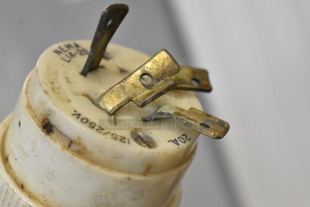 A close-up of a used electrical plug showing metal prongs, labeled "NEMA L14-20" and "125/250V, 20A".