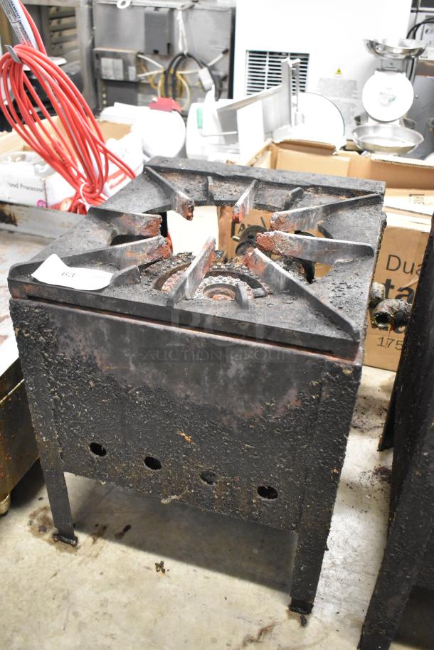 Metal commercial gas-powered single burner stock pot range, visibly worn with rust and wear, ideal for high-capacity cooking.
