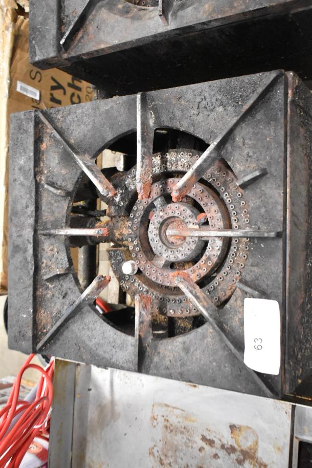 Metal commercial gas-powered single burner stock pot range, heavily used, rust spots, visible number 63 tag.