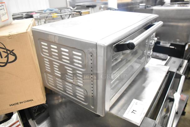 Metal countertop electric toaster oven, 120 volts, 1 phase. Visible wear. Box reads "Made in China." Auction tag number 71.