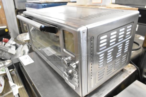 Stainless steel countertop electric toaster oven, 120 volts, 1 phase, with control knobs and a glass door.