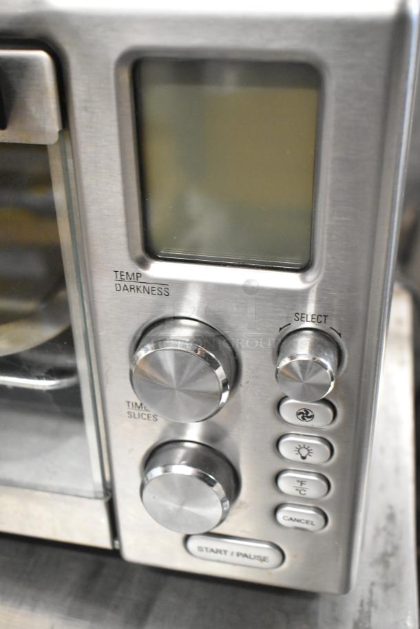 Metal countertop electric toaster oven, 120 volts, 1 phase. Features temperature and darkness dials, in good condition.